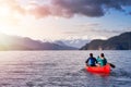 Couple friends canoeing on a wooden canoe Royalty Free Stock Photo