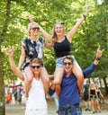 Couple of friends, carrying and woman on shoulders at music festival, celebration and cheers of fans. Happy, people or Royalty Free Stock Photo