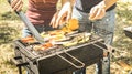 Couple of friends cooking vegetables on barbecue - Aubergines and peppers cooked on grill at bbq garden party - Pic nic concept