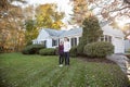 Couple standing in yard in front of house Royalty Free Stock Photo