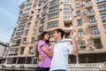 Couple in front of new home holding door keys and looking at each other. Royalty Free Stock Photo