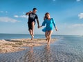 Couple Fun On Beach. Romantic People In Love Running On Sand At Luxury Sea Resort. Handsome Happy Man, Beautiful Smiling Woman Lau Royalty Free Stock Photo