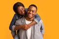 Couple Fun. Loving Black Guy Giving Piggyback Ride To His Laughing Girlfriend Royalty Free Stock Photo