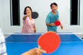 Couple fun playing table tennis indoor together Royalty Free Stock Photo