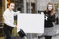 Couple funny mimes holding sign