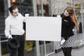 Couple funny mimes holding sign