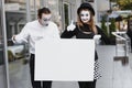 Couple funny mimes holding sign