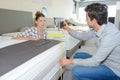 Couple in furniture store measuring bed Royalty Free Stock Photo