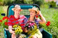 Couple in garden with flowers Royalty Free Stock Photo