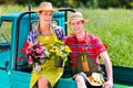 Couple in garden with flowers on gape