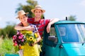 Couple in garden with flowers on gape Royalty Free Stock Photo