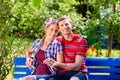 Couple in garden sitting on bench