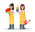 A Couple Of Gardeners. Women holding flowers, flower pot and watering can. Royalty Free Stock Photo