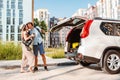 couple gathering for road trip. putting bags to car trunk Royalty Free Stock Photo