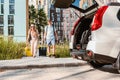 couple gathering for road trip. putting bags to car trunk Royalty Free Stock Photo