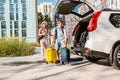 couple gathering for road trip. putting bags to car trunk Royalty Free Stock Photo