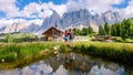 Couple at Geisler Alm, Dolomites Italy, hiking in the mountains of Val Di Funes in Italian Dolomites