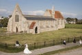 A couple gets recently married poses for the pictures outside Royal Garrison Church in Portsmouth