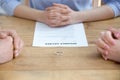 Couple getting divorced in lawyers office with decree paper, closeup