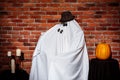 Couple of ghosts posing over brick background. Halloween party. Royalty Free Stock Photo