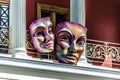 A Couple of Giant Carnival Masks ?anging from the ?alcony of a Theater in Patra City, Greece. Outdoor Venetian Decoration