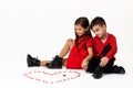 Couple girl and boy make big heart shape out of small paper hearts Royalty Free Stock Photo