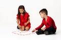 Couple girl and boy make big heart shape out of small paper hearts Royalty Free Stock Photo