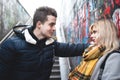 Couple - girl and guy near the wall