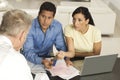 Couple Giving Documents And Credit Cards To Advisor Royalty Free Stock Photo