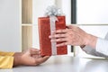 Couple giving gift box to each other with birthday greeting or celebration day and christmas Royalty Free Stock Photo