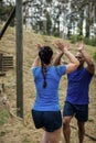 Couple giving high five to each other during obstacle course Royalty Free Stock Photo