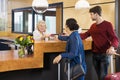 Couple Giving Passports To Receptionist