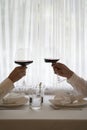 Couple with glass of red wine in a restaurant by the window Royalty Free Stock Photo