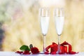 Couple glasses of champagne with beautiful red roses and gift on Royalty Free Stock Photo