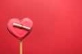 Couple glazed cookies in shape of heart with Love letter on red