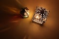 Couple of glowing Moroccan ornamental lanterns on table. Decorative golden shadows. Greeting card, invitation for Muslim Royalty Free Stock Photo