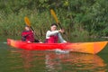 The couple goes kayaking on the river. Royalty Free Stock Photo