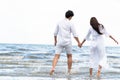 Couple going honeymoon on tropical beach in summer