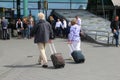 Couple travels with hand luggage from Amsterdam Schiphol airport, Netherlands Royalty Free Stock Photo