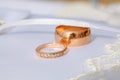 Couple of gold wedding diamond rings on wedding pillow