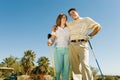 Couple of golfers embracing on golf course Royalty Free Stock Photo