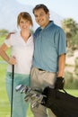 Couple of golfers embracing on golf course Royalty Free Stock Photo