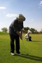 Couple of golfers on the green. Royalty Free Stock Photo