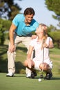 Couple Golfing On Golf Course Royalty Free Stock Photo