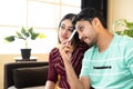 Couple got sad due to loss of living watching cricket game or lost connection while watching tv or television at home -