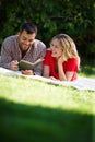 Couple, grass and picnic with book in portrait for relax, reading or together with notebook. Man, woman and nature for Royalty Free Stock Photo