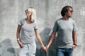 Couple in gray t-shirt over street wall