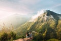 The couple greets the sunrise in the mountains