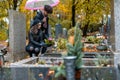 Couple in grief on a cemetery in fall Royalty Free Stock Photo