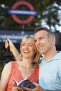 Couple With Guidebook Outdoors Royalty Free Stock Photo